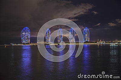 Pheonix Island Sanya illuminated buildings.Orange Bronze Unique modern Editorial Stock Photo