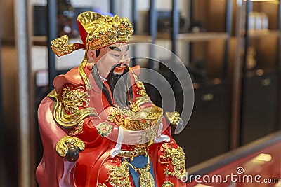 China, Hainan Island, Sanya : Chinese Sanya Central Market No. 1, Chinese souvenirs, a small buddha on the shop Editorial Stock Photo