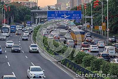 Evening traffic in big city, cars on divided highway road, traffic jam at street, busy urban view at sunset. Editorial Stock Photo