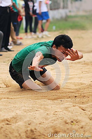 China: Student Track and Field Games / long jump Editorial Stock Photo