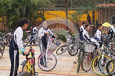 China students riding a bike after school Editorial Stock Photo