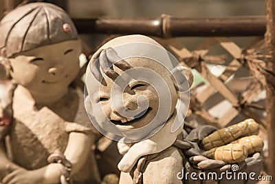 China,Suzhou-18 AUG 2017: smile face Pottery children boy figure closeup view Editorial Stock Photo