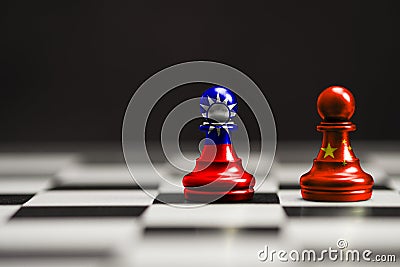 China and Taiwan flag print screen on pawn chess with black background. Now both countries have economic and patriotic conflict. Stock Photo