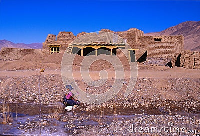 China-Tibet-December 2002- house under construction woman picks Editorial Stock Photo