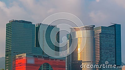 China timelapse. Kowloon district. Sunset views of the city from the port of Hong Kong. Sunny day. Stock Photo