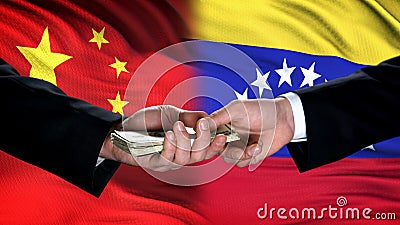 China and Venezuela officials exchanging money, flag background, cooperation Stock Photo