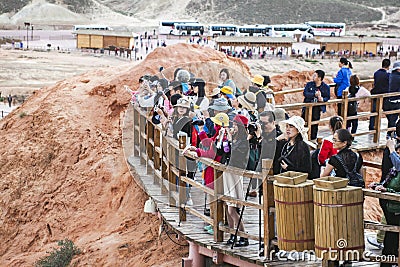 CHINA, ZHANGYE - SEPTEMBER 15, 2018. Tour Group Of Chinese People Taking Pictures Of Tourist Attraction. Asian Tourists Are Editorial Stock Photo