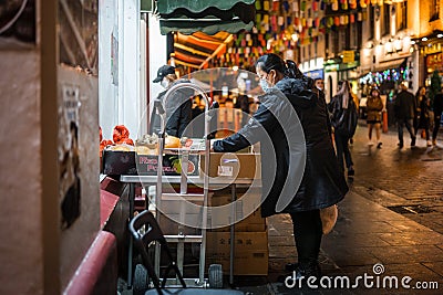 Chinese New Year celebrations in Chinatown at night low light with shops and people enjoying decorations Editorial Stock Photo