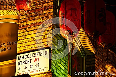 Street signage on red brick wall at night Red lantern in Chinatown London chinese new year Editorial Stock Photo