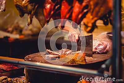 One cook slicing pork at a market stall Editorial Stock Photo