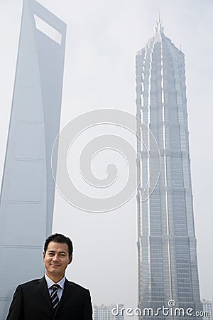 Chinese businessman near skyscrapers Stock Photo