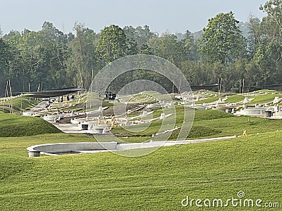 Chinese cemetery on the mound with large trees behind, Thailand Stock Photo