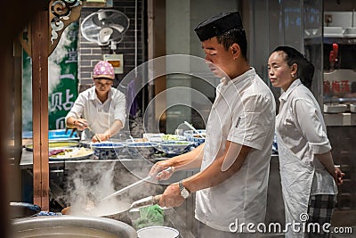Chinese chef preparing hot food Editorial Stock Photo