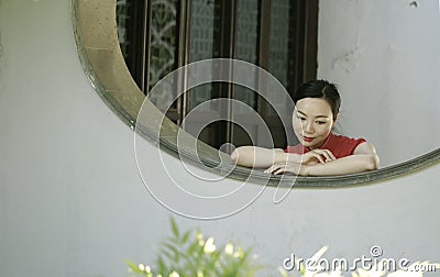 Chinese cheongsam model in Chinese classical garden Stock Photo