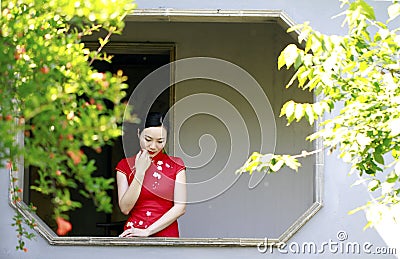 Chinese cheongsam model in Chinese classical garden Stock Photo