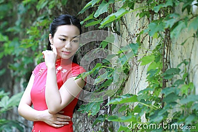 Chinese cheongsam model play in a famous garden Stock Photo