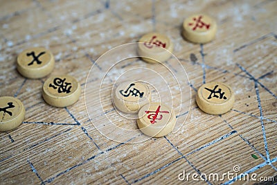 Chinese chess pieces made of wood on chessboard Stock Photo