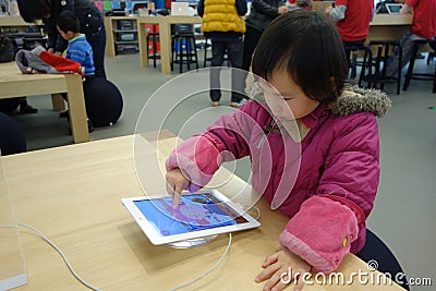 Chinese child playing ipad Editorial Stock Photo