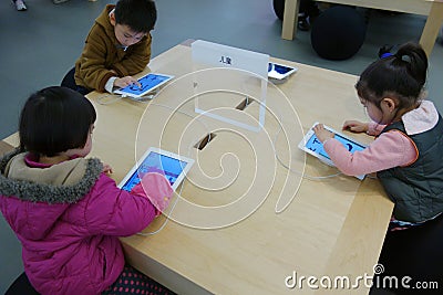 Chinese child playing ipad Editorial Stock Photo