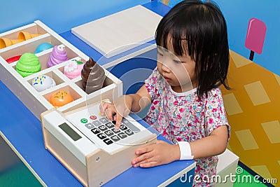 Chinese children role-playing at ice cream store. Stock Photo