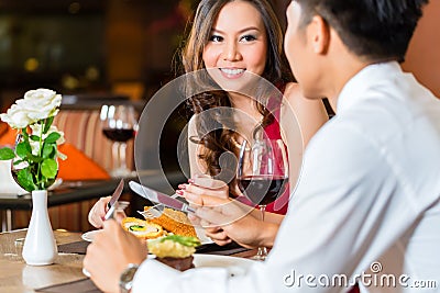 Chinese couple having romantic dinner in fancy restaurant Stock Photo