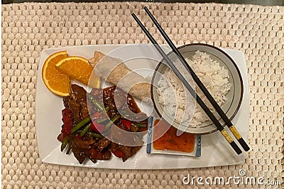 Chinese dinner served with rice, beef and spring rolls Stock Photo
