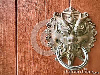 Chinese dragon head door knocker on wooden door. Stock Photo