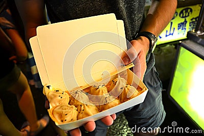 Chinese Dumpling in traveler hands Editorial Stock Photo