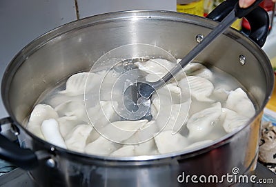 Chinese Dumplings Cooking in the Skillet Stock Photo