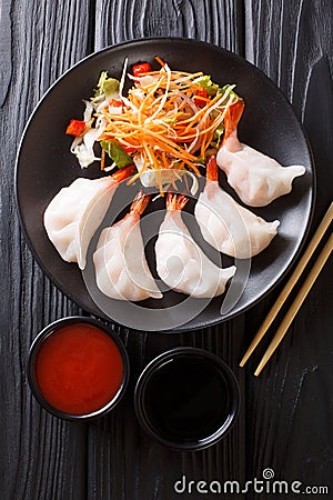 Chinese dumplings jiaozi with shrimps are served with vegetable Stock Photo