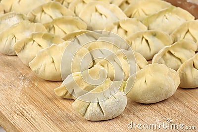 These Chinese dumplings jiaozi are traditionally eaten during Chinese New Year. Stock Photo