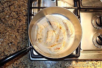 Chinese Dumplings Sizzle in a Frying Pan Stock Photo