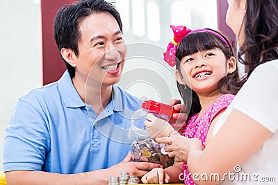 Chinese family saving money for college fund Stock Photo