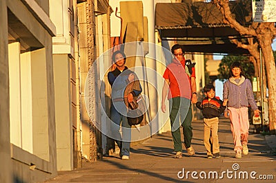 A Chinese family walking in Chinatown, Editorial Stock Photo