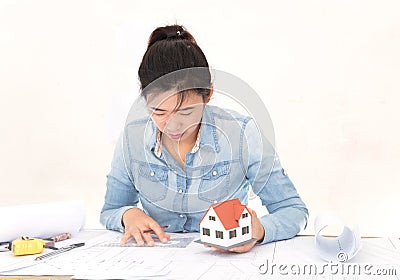 Chinese female architects are revising drawings compared to house models Stock Photo