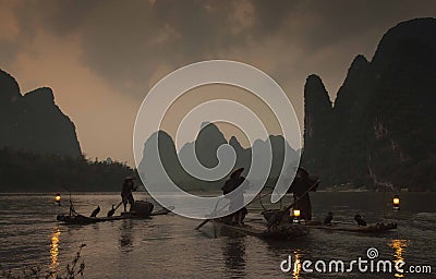 Chinese fishermen on the boat in mountains Editorial Stock Photo