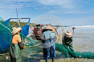 Chinese fishermen pulling the fishnet at the sea in Xitou Yangjiang, Guangdong, China Editorial Stock Photo