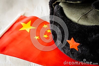 Chinese flag and military cap, Concept, China military expansion and aggressive policy Stock Photo