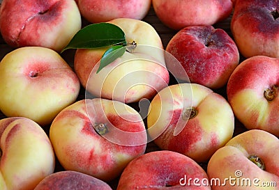 Chinese flat donut peaches also known as Saturn donut, Doughnut peach,Paraguayo as a background.Healthy eating or diet concept. Stock Photo