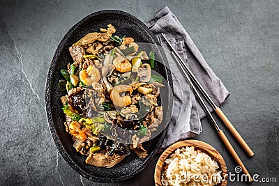 Chinese food. Te pam sao. Pan of fried different meat, shrimps shiitake mushroom Stock Photo
