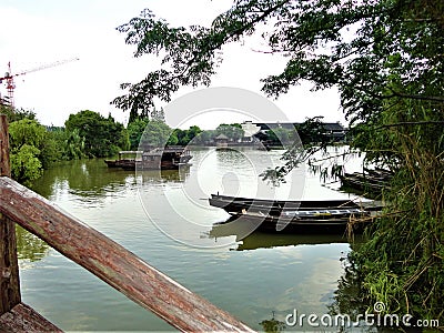 Chinese frame. Boats, lake, nature, village and development Stock Photo