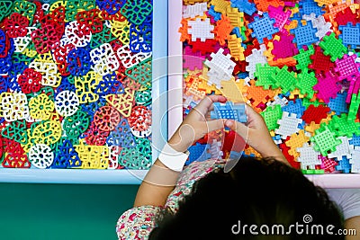 Chinese girl solving puzzle Stock Photo