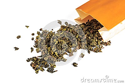 Chinese green teguanin tea, scattered on a white background, poured with a tea spatula and a tea filter. Stock Photo