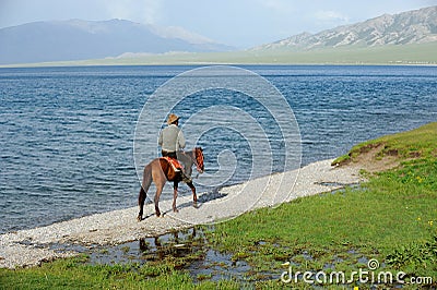 Chinese Kazakh herdsmen riding horse at Sailimu Editorial Stock Photo