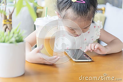 Chinese kid harmful lifestyle: smartphone and more sugar drink Stock Photo