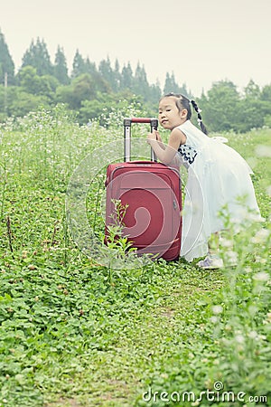 Chinese kid on trip with travel suitcase Stock Photo