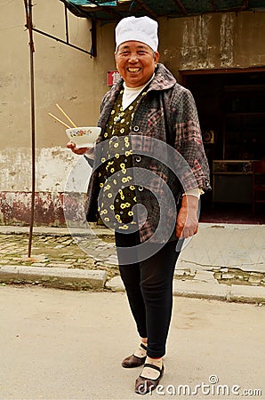 Chinese Lady by Home with Lunch Bowl, Kaifeng Editorial Stock Photo