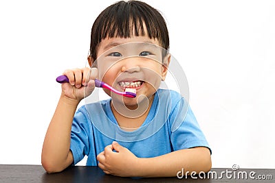 Chinese little girl brushing teeth Stock Photo