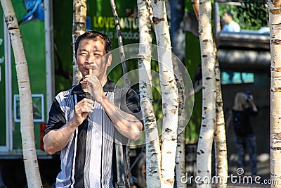 Chinese Man Playing Wooden Slide Whistle Editorial Stock Photo