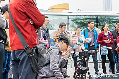 A Chinese man watching his camera and recording a man playing Chinese traditional musical instument Erhu in Shenzhen, China Editorial Stock Photo